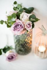purple, mauve color fresh summer roses in vase with white wall b