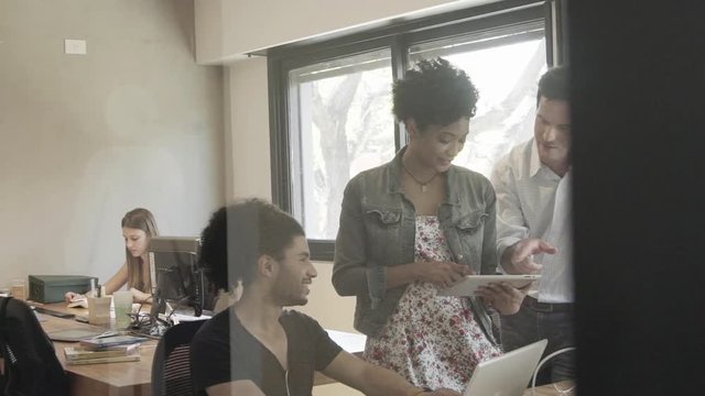 Colleagues collaborating in office