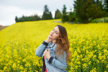 A young caucasian woman in rapeseed field