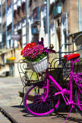 Fototapeta na wymiar pink bike standing on an old street