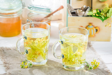 Healthy fresh tea with honey on old wooden table