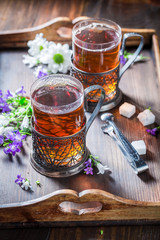 Delicious hot tea on old wooden table