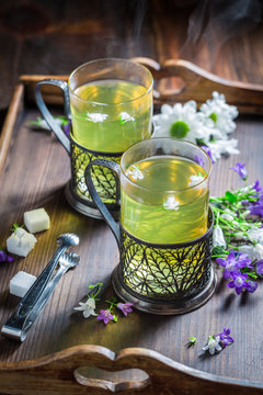 Aromatic hot tea with fresh green leaves