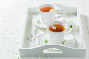 Fresh tea with honey with spring flowers