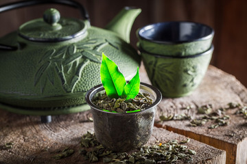 Aromatic green tea with iron teapot and cup