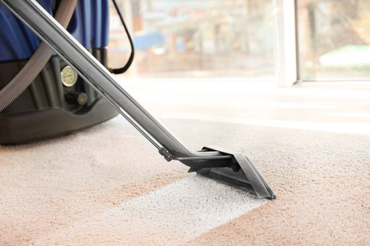 Steam vapor cleaner removing dirt from carpet in flat