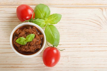red pesto on a wooden background