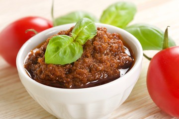red pesto on a wooden background