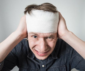 Man with bandage on his head