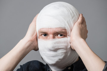 Man with bandage on his head