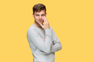 The young man smiling and looking at camera