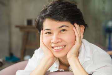 Young Beautiful Asian women sleeps and smile in the bedroom, lying on her bed at home.