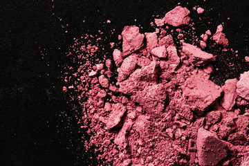 Broken pink blush on black table