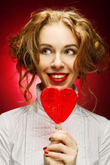 woman with heart caramel over red background 