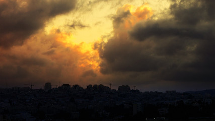 Sunset with huge cumuli clouds over the city. Jerusalem sunset at night dusk.