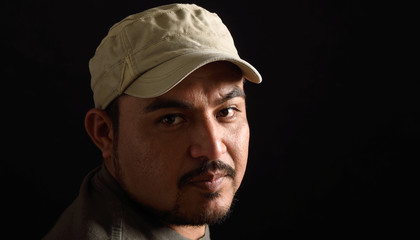 Portrait of a latin man on black background