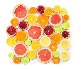 Slices of delicious citrus fruits on white background, top view