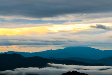 Landscape of sunrise and foggy over the mountain.