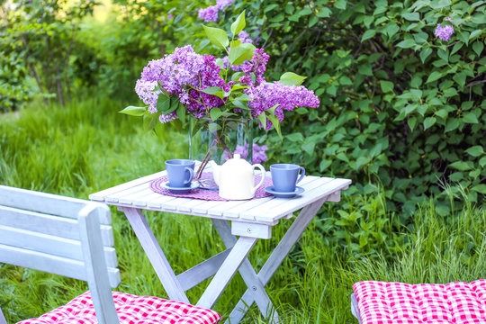 Lilac flowers on table in beautiful garden