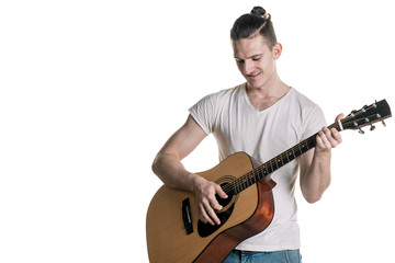 Music and creativity. Handsome young man in t-shirt playing on acoustic guitar. Horizontal frame