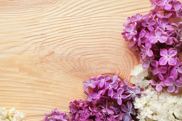 Beautiful lilac flowers on wooden background