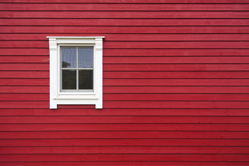 Detail of red wooden house with window