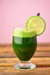 Green smoothies on wooden table