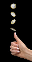 Woman's hand tosses a coin