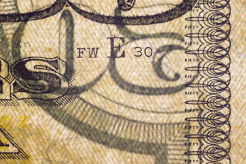 Macro elements on the US fifty dollar bill, selective focus with shallow depth of field. US dollars background.