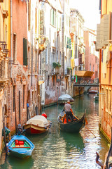 Obraz na płótnie Canvas Gondolas sailing in canal, Venice, Italy