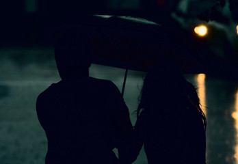 A young couple walking in the rain