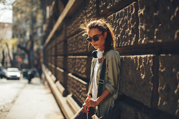 Young urban girl posing on sidewalk