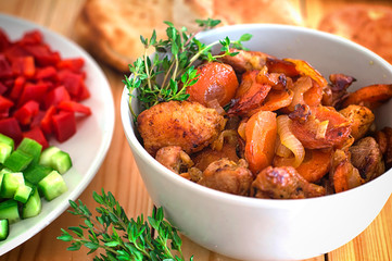 Stewed lamb with onions and carrots. Selective focus. Wooden background. Close-up. Top view