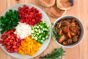 Vegetarian breakfast. Boiled rice with fresh vegetables. Wooden background. Close-up. Top view