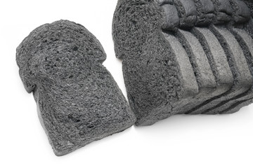 loaf slide of charcoal bread black bread isolated on white