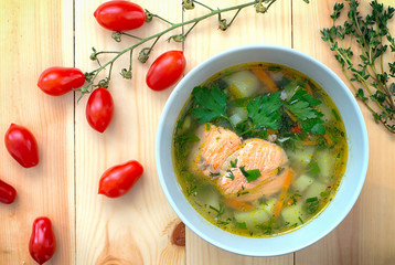 Soup with salmon. Wooden background. Top view. Close-up