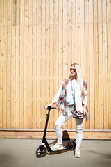 Blonde on scooter looking away