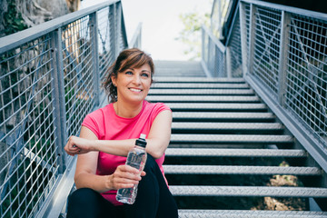 Middle aged woman relaxing after training