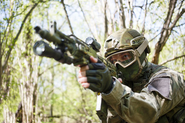 Fototapeta premium Military man aiming with gun