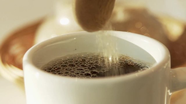 Adding sugar to coffee