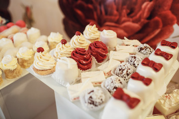 Cookies covered with red and white icing served on the table