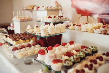 Cookies covered with red and white icing served on the table
