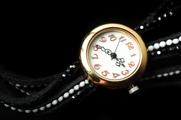 Ladies watch, on a black background