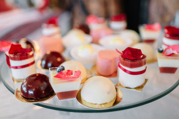 Sweets with strawberries and blueberries lie on a glass dish