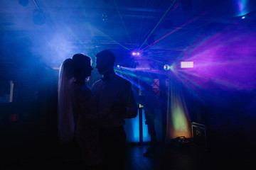 Wedding couple dances in blue light