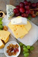 Assorted of cheeses with grapes and walnuts