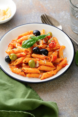 Penne Pasta with tomato sauce in white bowl