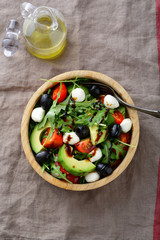 Light Avocado Salad with cherry tomatoes, mozzarella, olive and arugula