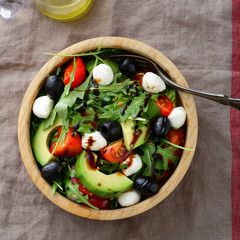Fresh Salad with avocado, tomatoes, mozzarella, olive and arugula