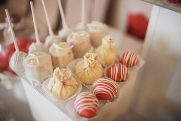 Cookies covered with pink and white icing served on the table
